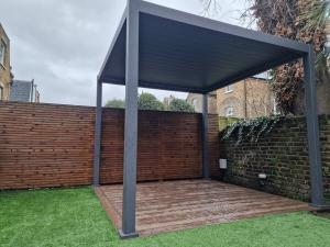 Garden View of a new Millboard Decking Installation with an Aluminium Pergola