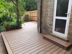 View of newly installed Trex Composite Decking installed in Wimbledon SW19 with step by rear door to house