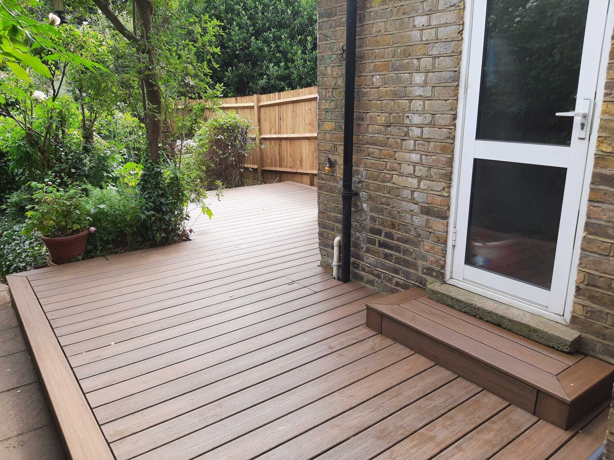 View of newly installed Trex Composite Decking installed in Wimbledon SW19 with step by rear door to house