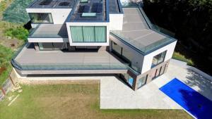 Photo shows an aerial view of 3 rooftop decks made by Oilcanfinish Outdoor Living in Trex Transcend Lineage Biscayne Composite Decking in Wentworth Estate, Virginia Water, GU25